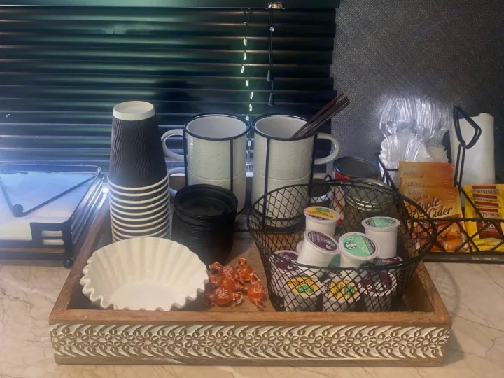 Convenient RV rental coffee & tea station with K-cups, mugs, disposable cups, and tea bags on a decorative tray.. Forest River Vibe 2021