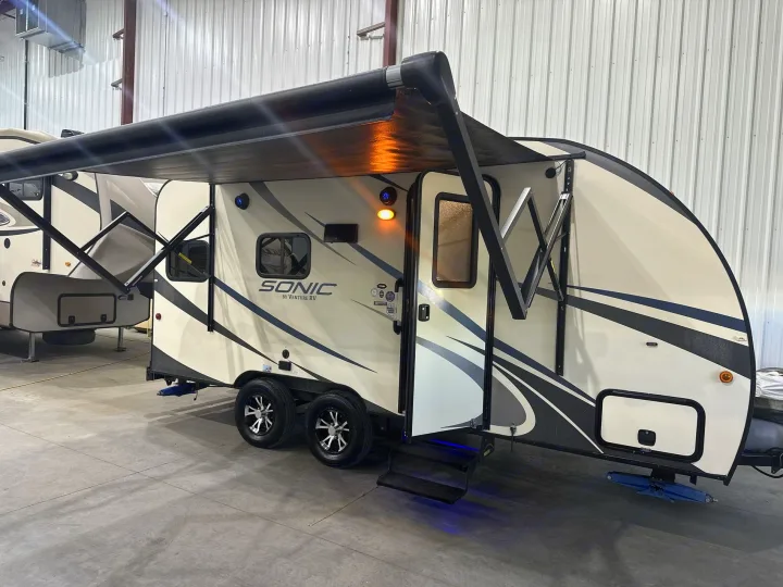 Explore the open road with this sleek Sonic travel trailer RV rental, complete with an extended awning and illuminated steps.. Venture RV Sonic 170 VBH 2017