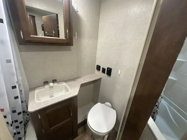 Inside an rv rental, this compact bathroom features a sink, vanity, toilet, and shower/tub combo, providing all essentials.. Venture RV Sonic 170 VBH 2017