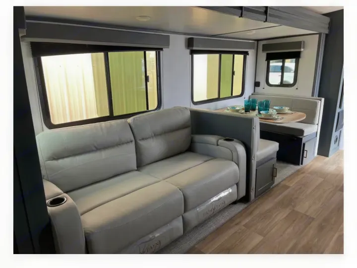 Tour this modern rv rental's inviting living space, complete with a comfy sofa, dining booth, and bright windows.. Keystone RV Bullet Ultra Lite 2022