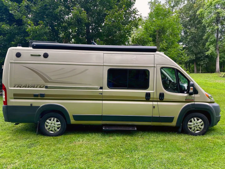 Winnebago Travato camper van on grass, ideal for your next rv rental adventure or camping trip.. Winnebago Travato 2014
