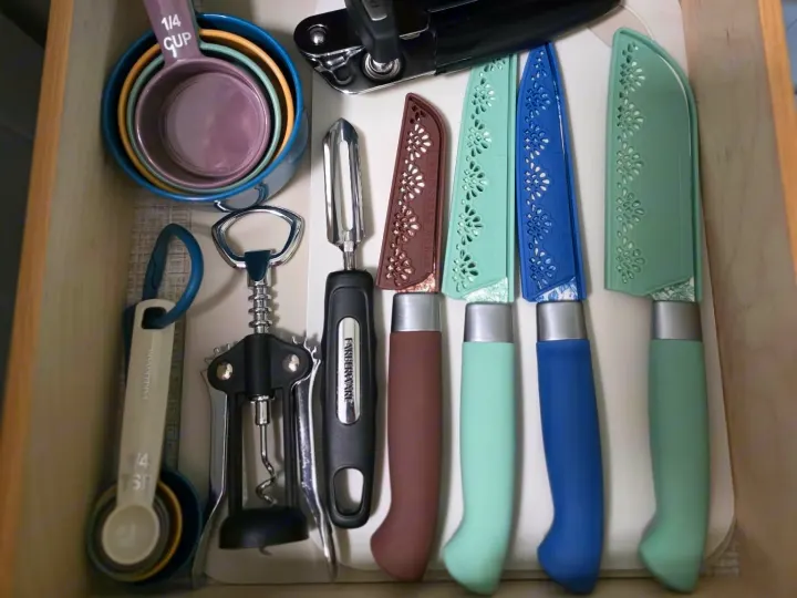 RV rental kitchen drawer: compact measuring cups, spoons, corkscrew, peeler, & knives. Perfect for your RV trip!. Keystone RV Bullet Ultra Lite 2021