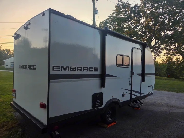 White Embrace travel trailer parked outdoors at dusk, a perfect RV rental for your next adventure.. Cruiser RV Embrace 2025
