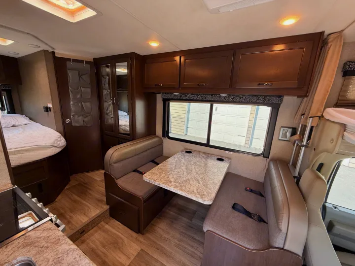 Experience comfort in this RV rental! Bright interior features a dinette, kitchen, and bed, complete with wood-look floors & storage.. Thor Freedom Elite 2020