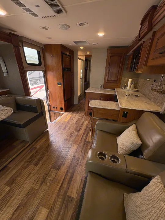 Step inside this inviting RV rental: spacious kitchen, comfortable lounge, and dinette with wood-look floors.. Jayco Precept 2017