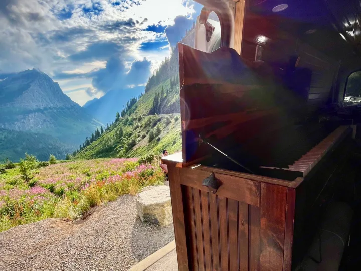 Breathtaking mountain vista from an RV rental, showcasing an interior piano setup. An ideal escape for music and nature lovers.. Ford Transit 350 High Roof EXT 2020