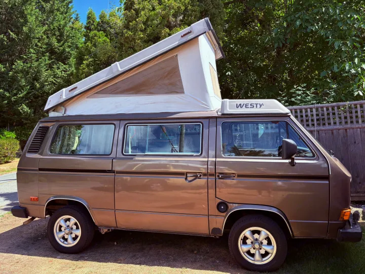 Brown VW Westfalia pop-top camper van with "WESTY" logo, ready for your next RV rental adventure.. Volkswagen Westfalia 1986