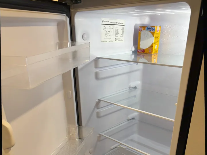 This clean, empty RV rental refrigerator is ready for your trip. An odor absorber keeps it fresh for your groceries.. Jayco Jay Flight SLX 2024
