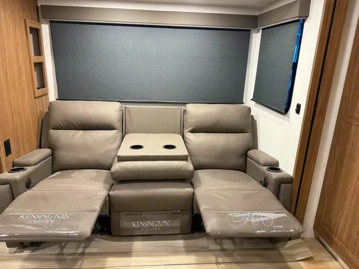 RV rental: Modern gray reclining sofa with cup holders and blackout blinds in a cozy RV interior.. Alliance RV Delta 2025