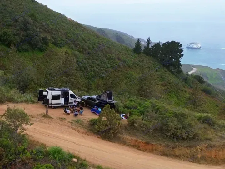 Friends with an rv rental and truck camp on a scenic coastal dirt road, overlooking the ocean. An ideal outdoor adventure.. Winnebago Revel 2021