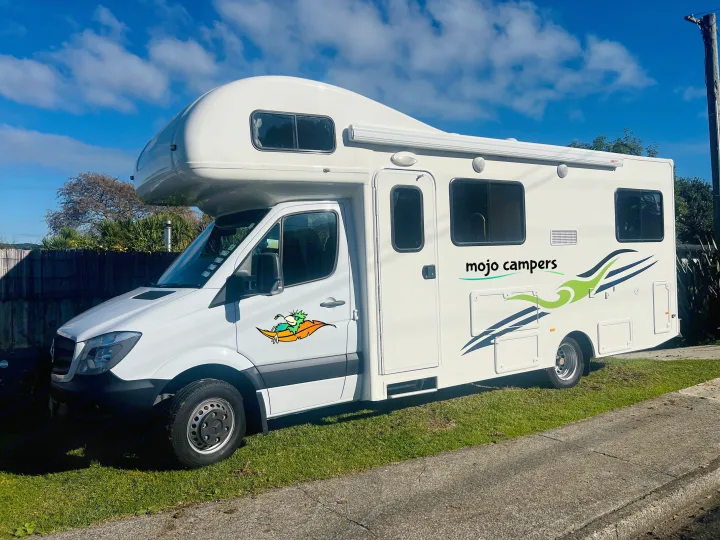 White Mojo Campers RV rental, a clean campervan featuring a unique bird graphic and modern decals, parked on grass.. Mercedes-Benz Other 2018