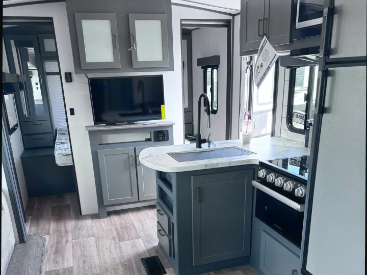 Modern RV rental interior with a compact kitchen, living area, and smart amenities. Ready for adventure!. Keystone RV Bullet Ultra Lite 2022