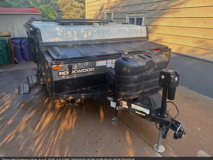 This black Rockwood pop-up camper, an ideal rv rental, shows its durable design and propane tanks, ready for adventure.. Forest River Rockwood ESP 2022