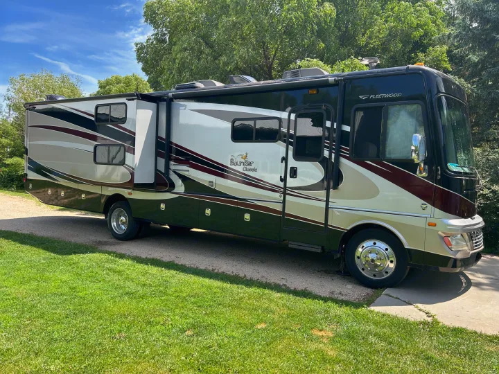 Spacious Fleetwood Bounder Classic RV rental parked on a sunny day, ready for your next outdoor adventure.. Bounder Classic 2014