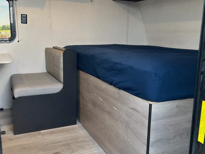 RV rental interior with a cozy bed, seating, and window view. Perfect for road trip comfort.. Cruiser RV A-17BH Avenir 2024