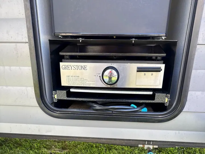 This RV rental features a convenient Greystone outdoor stove/grill for easy outdoor cooking and campsite meals.. Forest River Campsite Reserve 2025
