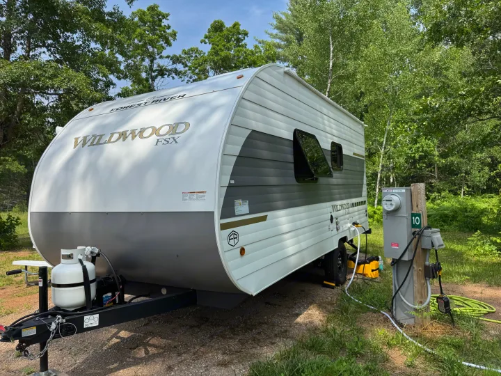 This RV rental, a Forest River Wildwood FSX travel trailer, is parked at campsite 10, ready for an outdoor adventure.. Forest River Wildwood FSX 2026
