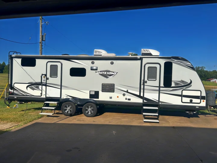 White Hawk travel trailer RV rental, sleek and modern with black accents, ready for adventure.. Jayco White Hawk 2019