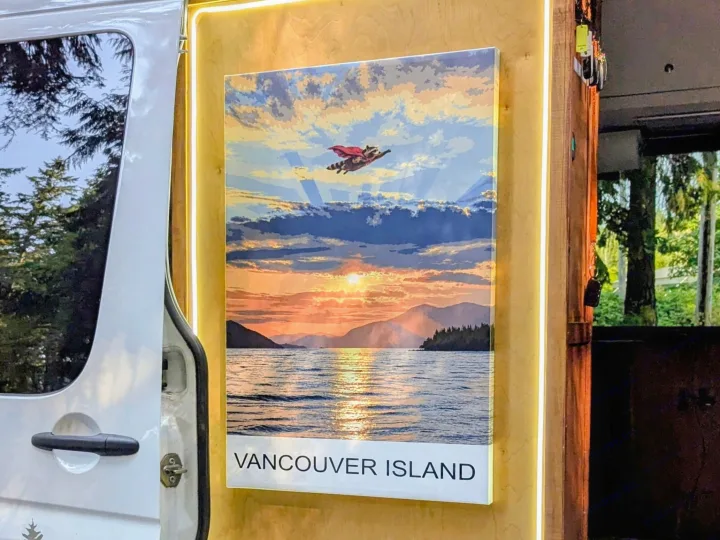 Cozy RV rental interior with a vibrant Vancouver Island sunset art print and flying raccoon superhero, illuminated by LEDs.. Mercedes Sprinter 2008