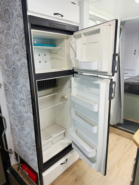 RV rental: Clean, open refrigerator and freezer, featuring decorative paneling. Ready for your adventure!. Thor Majestic 2014