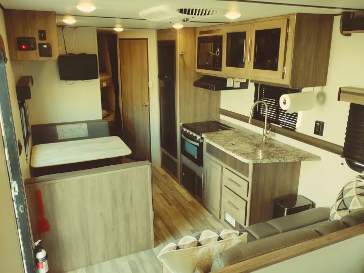 Cozy rv rental interior: modern kitchen, dinette, sofa, and bunks. Well-equipped for travel and adventure.. Crossroads RV Zinger Lite 2020