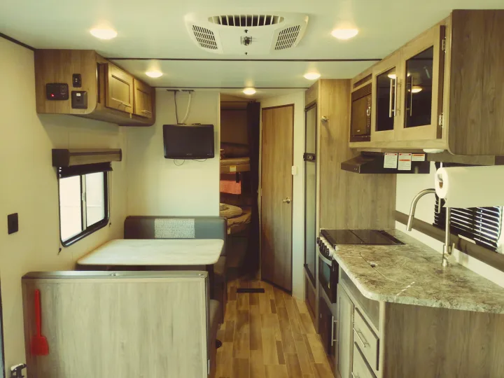 Inside this rv rental: kitchenette, dinette, and bunk beds, offering comfort and convenience for travel.. Crossroads RV Zinger Lite 2020