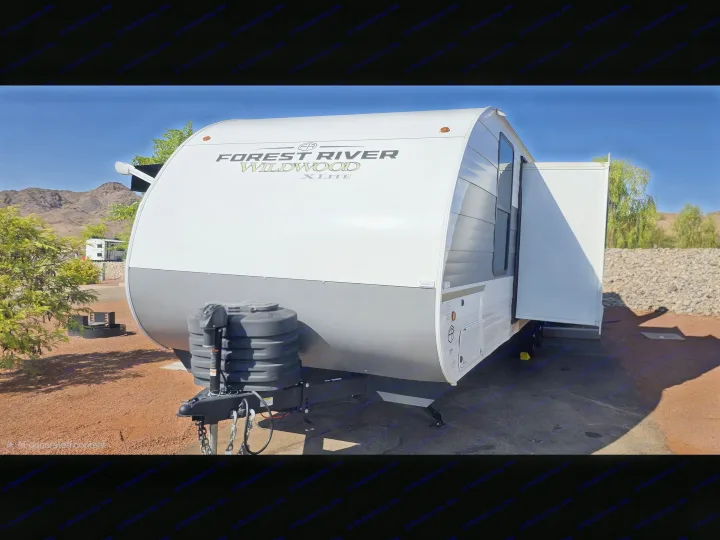 This Forest River Wildwood X-Lite travel trailer rv rental is ready for adventure at a scenic mountain campsite.. Forest River Wildwood X-Lite 2025