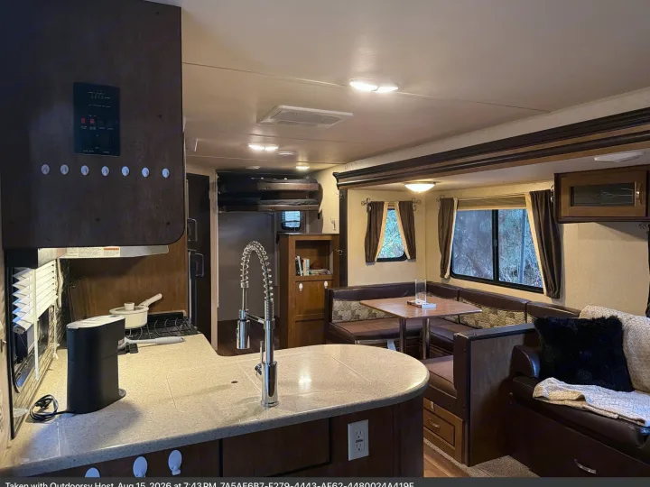 Spacious RV rental interior with a well-equipped kitchen, comfortable dinette, and cozy lounge seating.. Forest River T27TDSS 2017