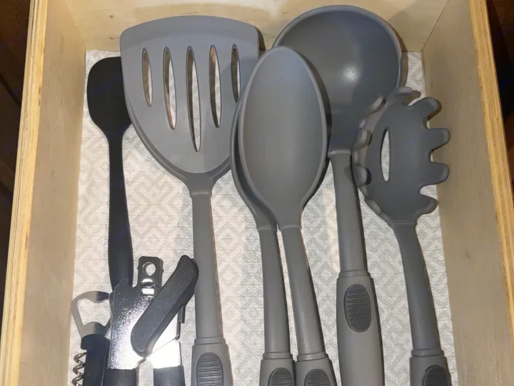 Essential cooking utensils neatly stored in an RV rental drawer, ready for your road trip meals.. Forest River T27TDSS 2017