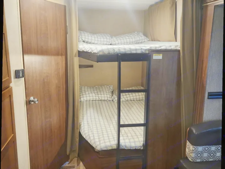 This RV rental offers space-saving bunk beds with plaid bedding & a ladder. A compact, cozy sleeping area for your next road trip adventure.. Aspen Trail Aspen Trail Trailer 2018