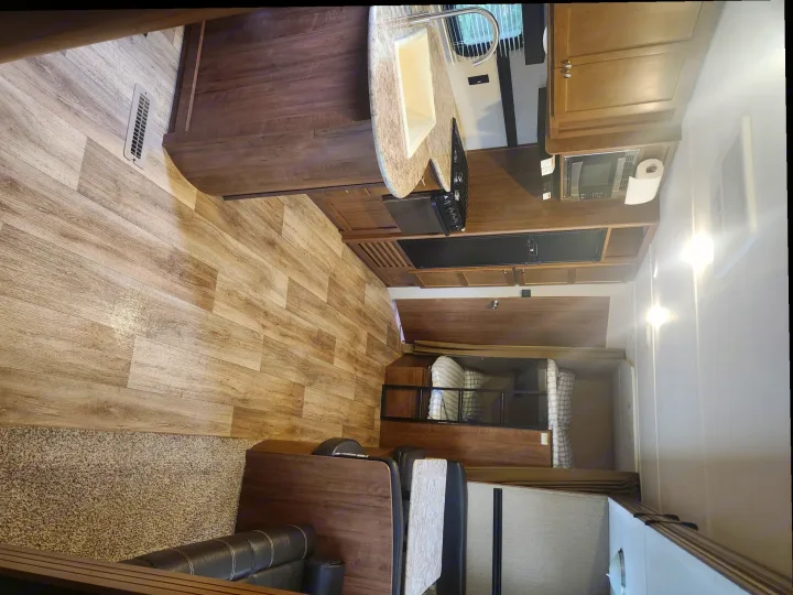 Spacious RV rental interior showing a full kitchen, comfortable dinette, sofa, and bunk beds. Ideal for your next adventure.. Aspen Trail Aspen Trail Trailer 2018
