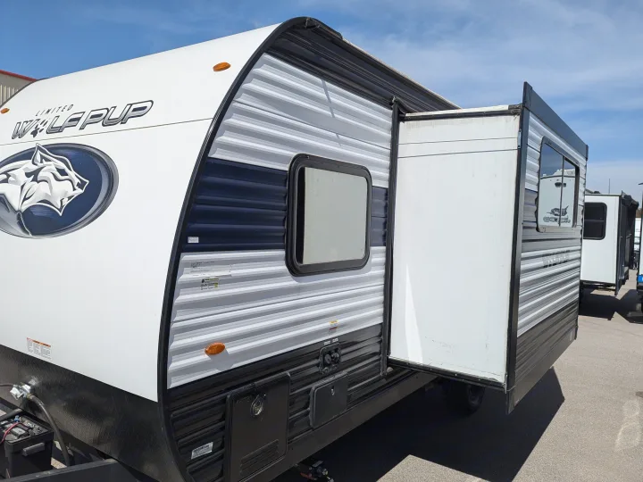"Wolf Pup" travel trailer RV rental with its side slide-out extended, showcasing exterior features and utilities.. Forest River Cherokee Wolf Pup 2024