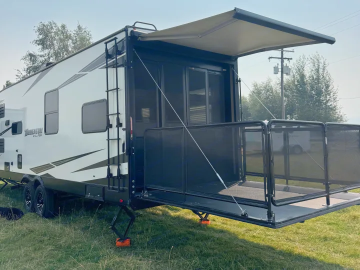 This toy hauler RV rental features a rear patio deck with an extended awning for outdoor enjoyment.. Grand Design Momentum 2022
