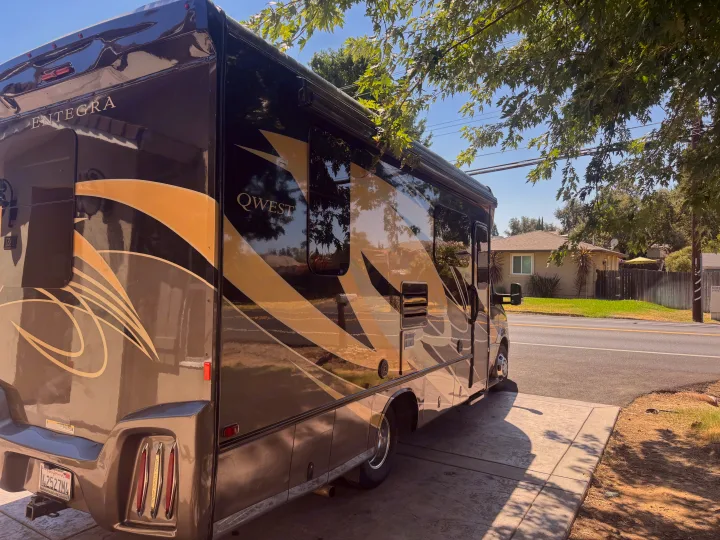 Luxurious Entegra Qwest RV rental, parked on a sunny driveway, ready for adventure.. Entegra Coach Qwest 2018