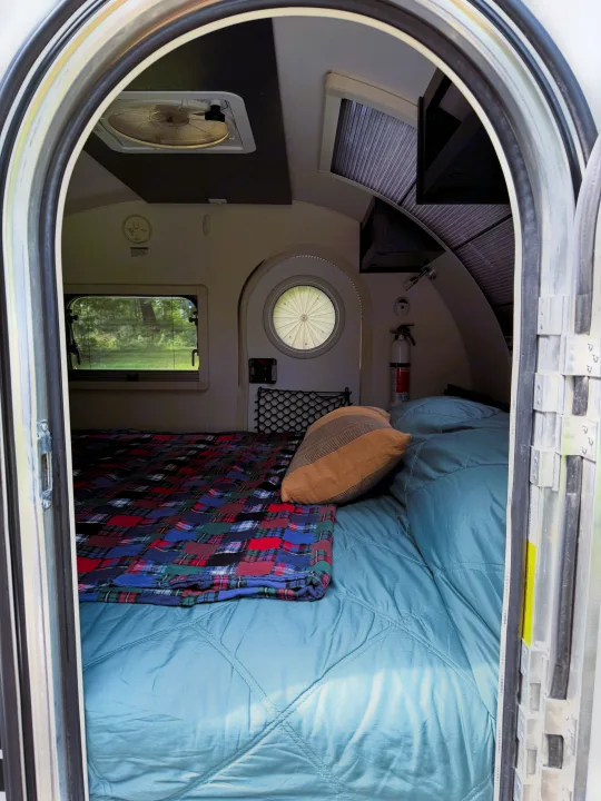 Step inside this cozy RV rental teardrop camper! Features a comfortable bed, window views, and essentials for compact travel.. nuCamp T@G 2022