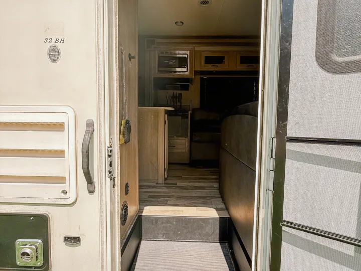 RV rental: The open door welcomes you inside, revealing the kitchen, living area, and a glimpse of the "32 BH" model.. Coachmen Freelander 2015