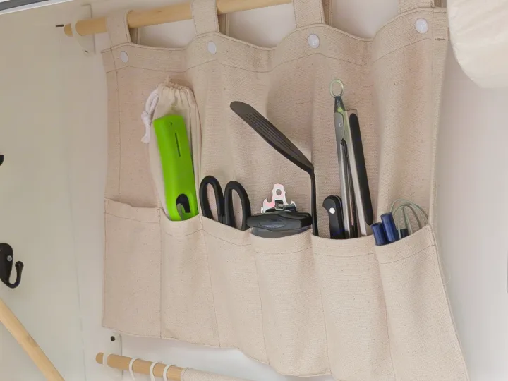 This hanging fabric organizer with kitchen tools provides smart storage for an RV rental.. MiniTrail Custom 2018