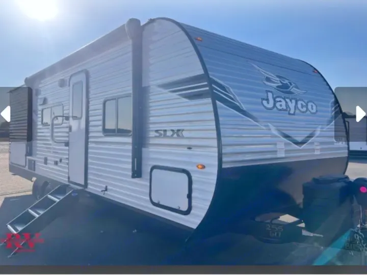 This Jayco SLX travel trailer, ideal for rv rental, features a sleek silver and black exterior with an awning and steps.. Jayco Jay-flight 2026