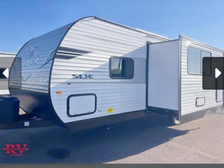 White Jayco SLX travel trailer with a slide-out extended, parked on asphalt. Ideal for an RV rental.. Jayco Jay-flight 2026