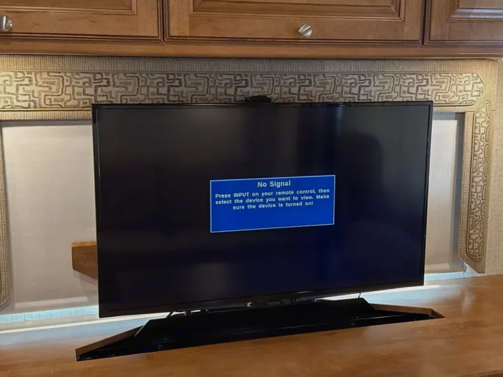 RV rental: TV displays a "No Signal" message, prompting user to select input or turn on the connected device.. Winnebago Vista LX 2017