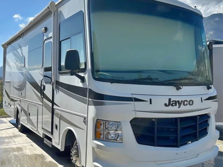 This spacious white Jayco RV rental, featuring sleek black and grey stripes, is ready for your next adventure.. Jayco Alante 2018