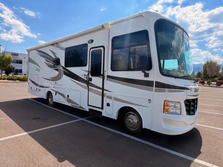 This white Jayco Alante RV rental gleams under a sunny sky, parked in a lot, ready for your next adventure.. Jayco Alante 2018