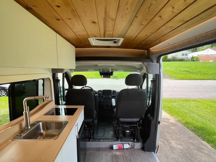 Spacious camper van rv rental interior with wooden ceiling, kitchenette, sink, and driver's cabin. Ready for adventure!. Dave & Matt Vans Dave & Matt Vans Class B 2023