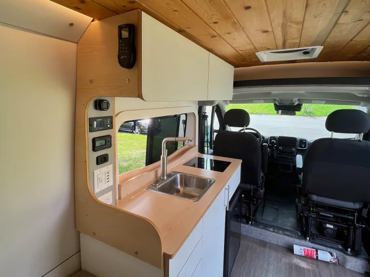 Modern rv rental interior showcases a functional kitchen, detailed control panel, and beautiful wooden ceiling.. Dave & Matt Vans Dave & Matt Vans Class B 2023