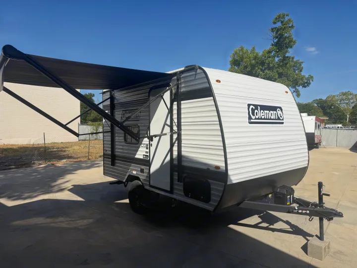 Bright Coleman travel trailer RV rental with extended awning, perfect for shaded outdoor living.. Keystone RV Coleman 2026