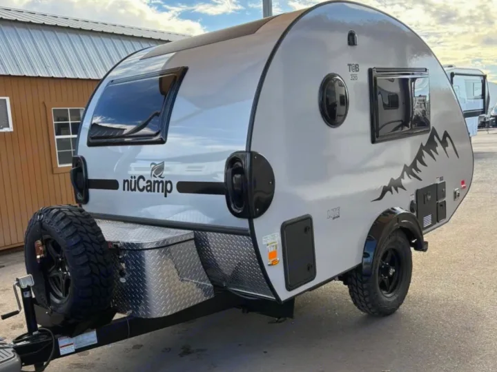 nuCamp T@B 320 Lite teardrop camper, ideal for rv rental adventures. Features off-road tires & mountain graphics.. nuCamp T@B 2026