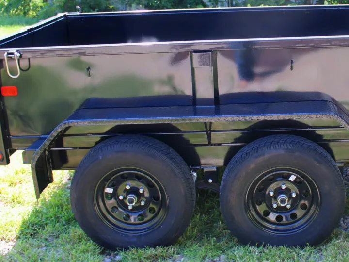 Black dual-axle utility trailer for RV rental, with diamond plate fenders. Perfect for hauling extra gear.. Big Tex 70SR 2027