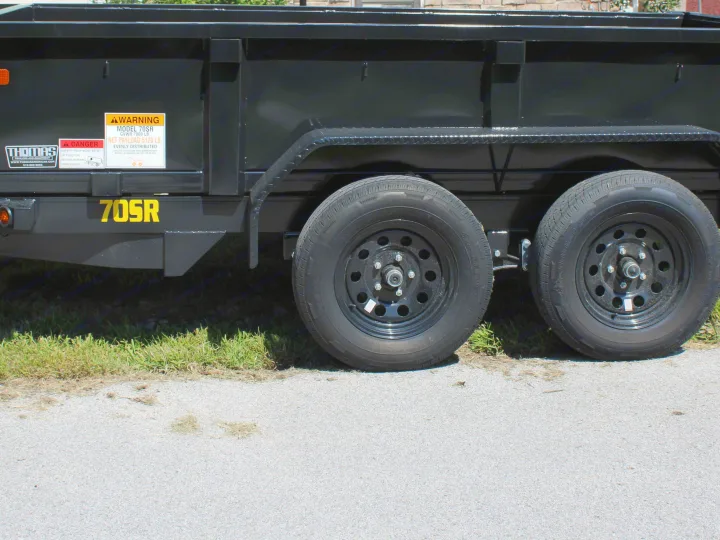 Thomas 70SR dump trailer (7000 lb GVWR) with warnings. Robust utility equipment, complementing an rv rental trip.. Big Tex 70SR 2027
