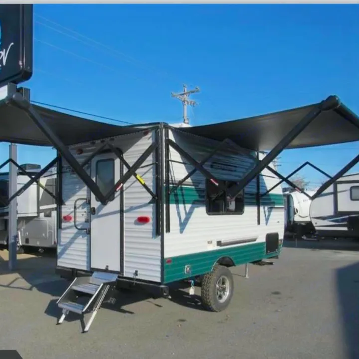 Adventure-ready RV rental with deployed awnings and off-road tires, perfect for camping.. Sunset Park RV Sun Lite 2025