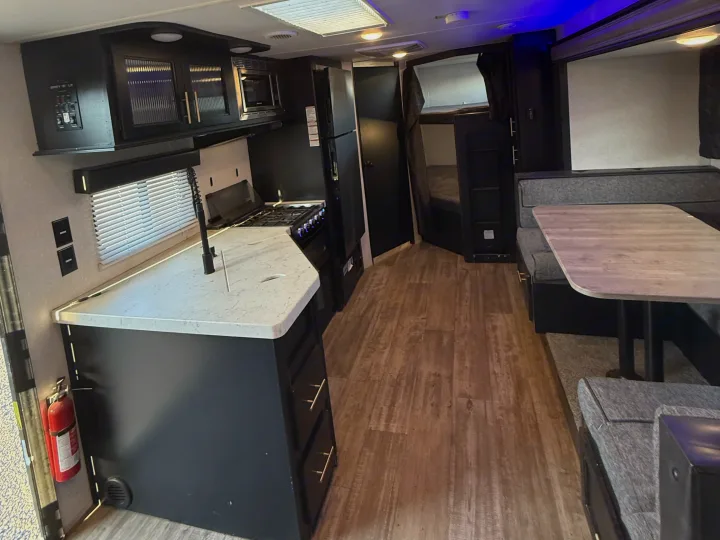 RV rental interior: modern kitchen, dinette, and bunk beds. Perfect for a comfortable travel adventure.. Forest River Cherokee Grey Wolf 2021
